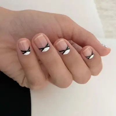 Black-and-white criss-cross nail designs at the cuticle