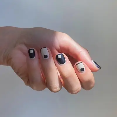 Black-and-white nail designs with simple alternating dots