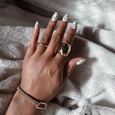 White nails with black squiggle designs