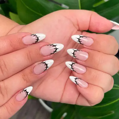 Nude nails with oval white French tips and black barbed wire outlines