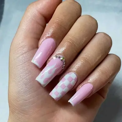 Baby pink manicure with checkerboard and flame prints. 