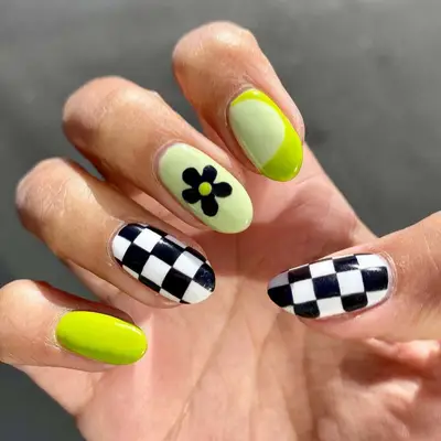 Green nails with black checkerboard accents