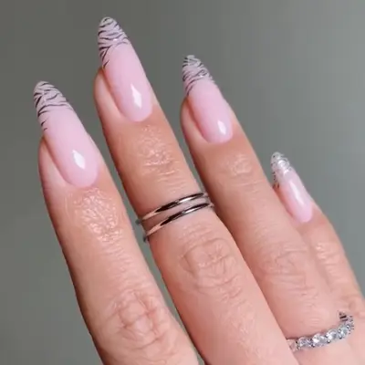 Manicure with silver chrome zebra tips and rings on fingers