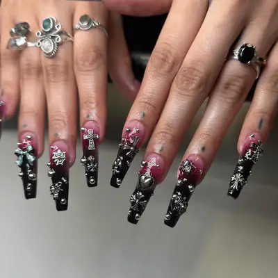 Nude acrylic nails with silver tips and septum piercing on ring finger tip