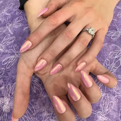 Person with pink chrome acrylic nails