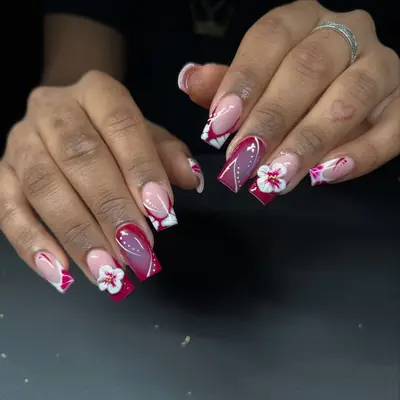 Person with floral-inspired acrylic nails