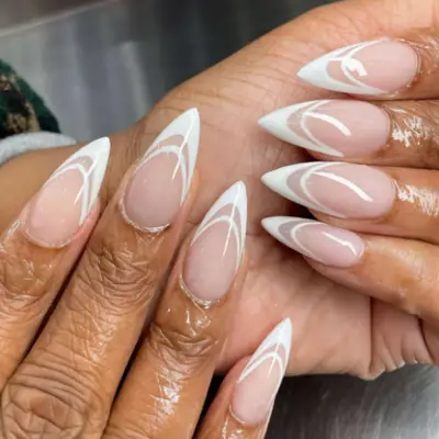 Double French manicure in white with pointed tips.