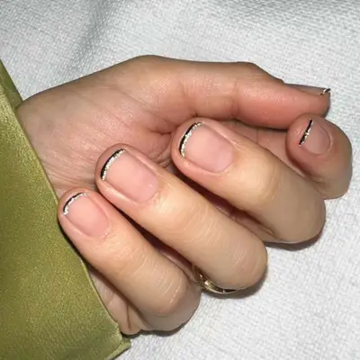 Double French manicure with a thin black line and a thin silver line.