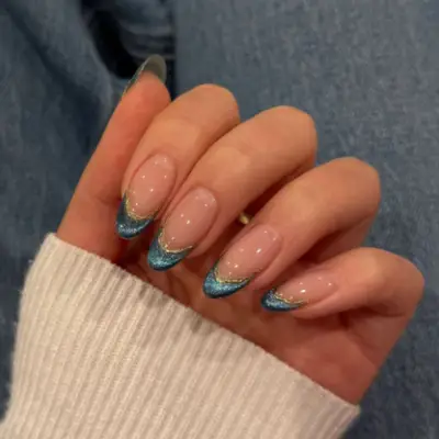 Duochrome blue and silver French tips.