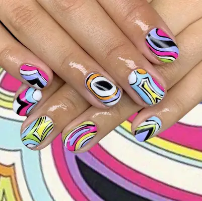 Colorful abstract swirl design on manicured nails