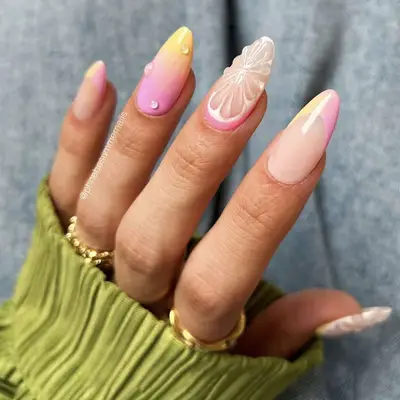 Hand with nail art featuring an intricate floral design on long nails