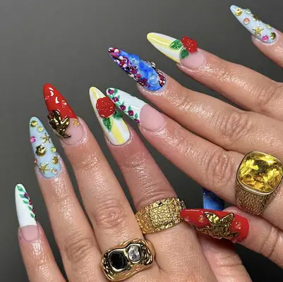 Hands with decorative long nails, wearing multiple rings