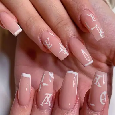 Neutral short coffin nails with white tips and Louis Vuitton logo design