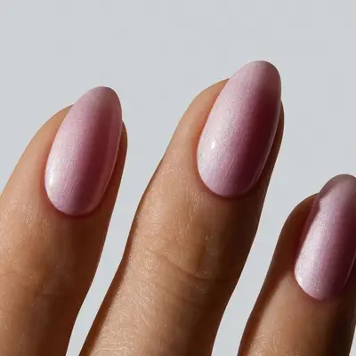 model with shimmery chrome pink nails