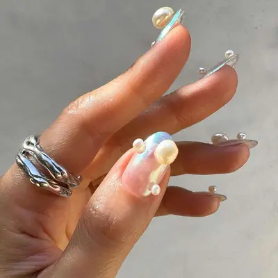 model with sheer iridescent nails with pearls