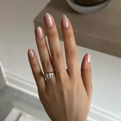 model with pearlescent pink nails with subtle french tip