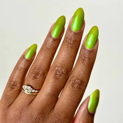 model with neon green chrome nails
