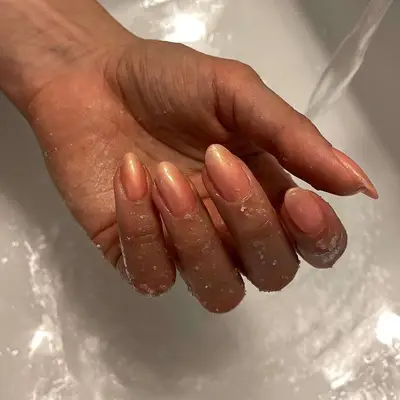 model with peach iridescent nails 