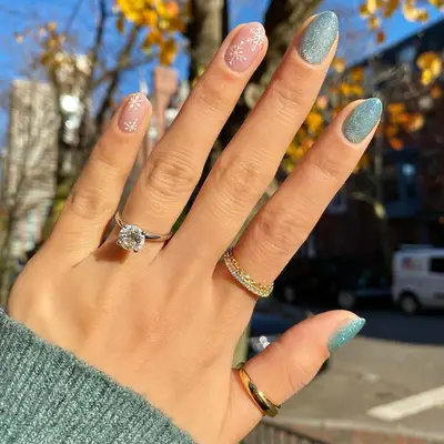 Blue velvet manicure with pink accent nails with white snowflakes