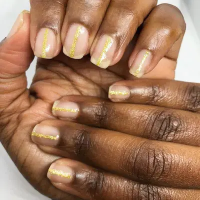 Clear nails with gold glitter central stripes