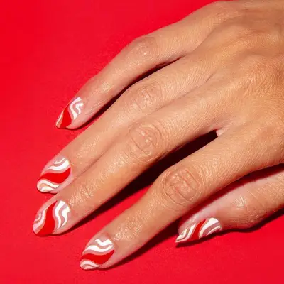 Neutral nails with red and white abstract candy cane stripes