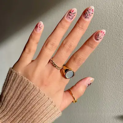 Clear nails with silver and red mistletoe design