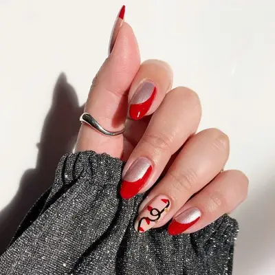 Red and silver Christmas manicure with holiday light design accent nails