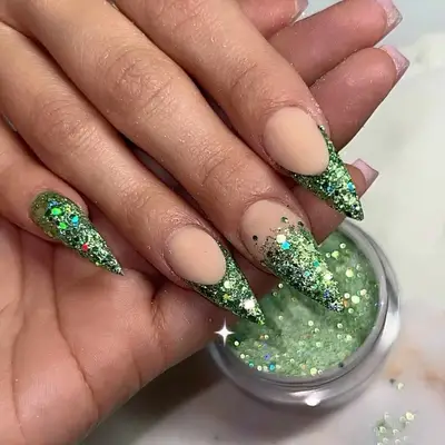 Pointy manicure with green glitter French tips