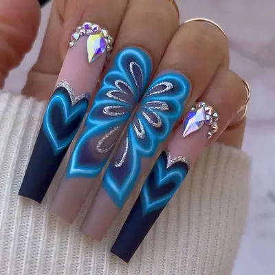 Black and blue neon sign-inspired matte nail design with gemstone cuticle accents