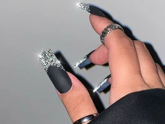 Matte black nails with glittery French tips