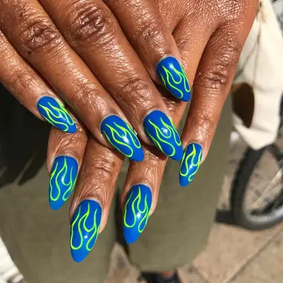 a blue manicure with green flames