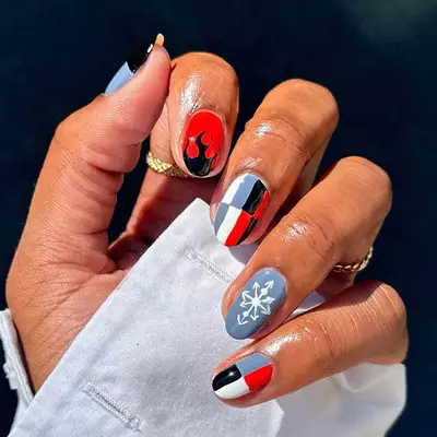 a manicure with flames, checkerboards, and snowflakes