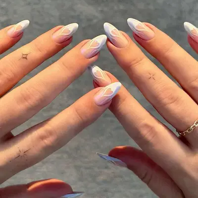 a chrome french manicure with white flames