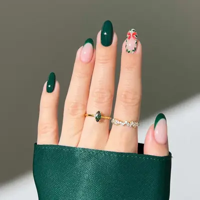 manicure with green christmas nails and red bow with wreath on one finger