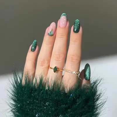 manicure with sparkly green christmas nails, one nail with christmas tree