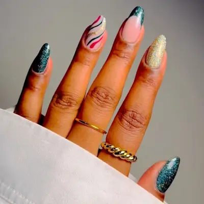 manicure with green christmas nails, swirly gold red nails, and one gold nail