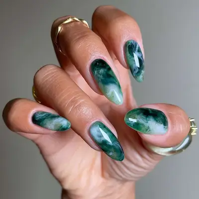 a dark and stormy emerald green marble manicure