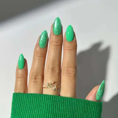 a bright green manicure with foliage accents