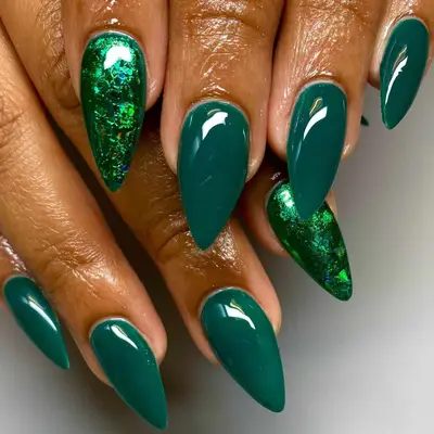 an emerald green manicure with foil accent nails