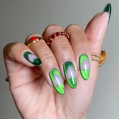 a green velvet manicure with negative space heart cutouts