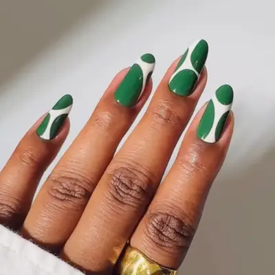 an emerald green and white blob manicure