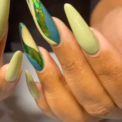 a multifinish manicure with matte fingers, swirls, and foil accents