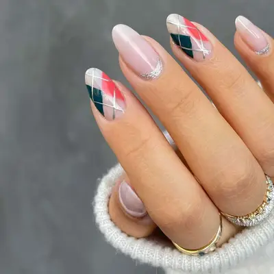 Close-up of plaid sweater nails with silver glitter cuticle half-moon accents
