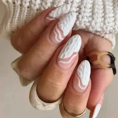 Close-up of white sweater design manicure