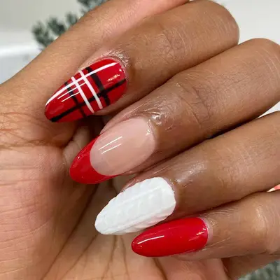 Manicure with red and white knit pattern, red French tip, red solid nail, and plaid
