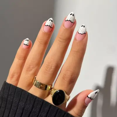 Nude manicure with ghosts covering the tips.