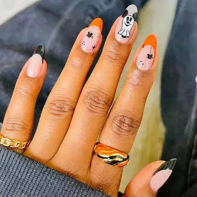 Disney-themed Halloween manicure with ghosts and spiders wearing Mickey ears.