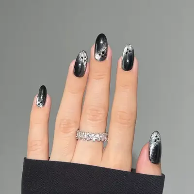 Gray/silver velvet manicure with tiny ghost faces.