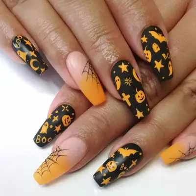 Black manicure with halloween motifs in orange and an accent nail with spider webs.
