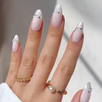 Manicured hand with decorative nails and jewelry